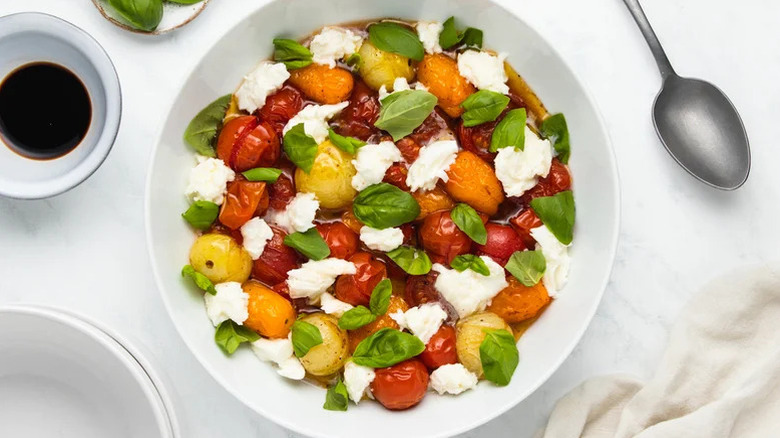 Bowl of caprese salad with mozzarella and basil