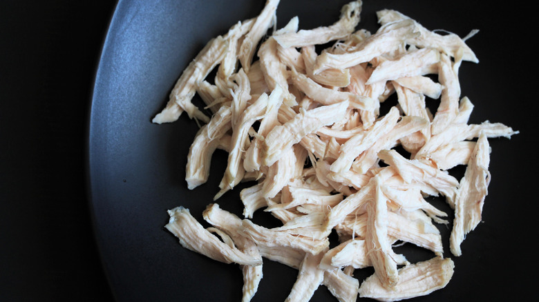 Shredded chicken on black plate