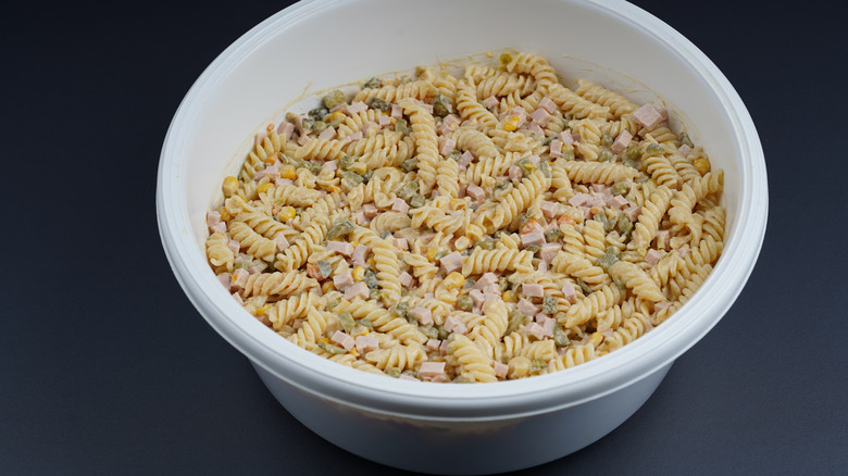 Ham pasta salad in white bin