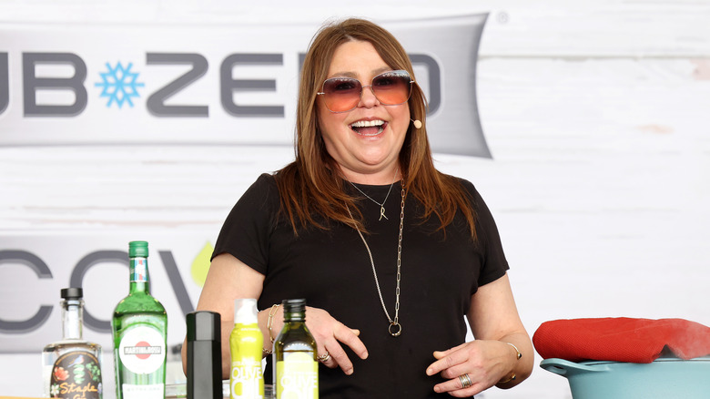 Rachael Ray smiling during a cooking demonstration.