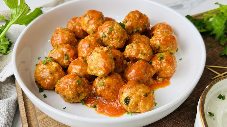 Buffalo chicken and gorgonzola meatballs in a white dish