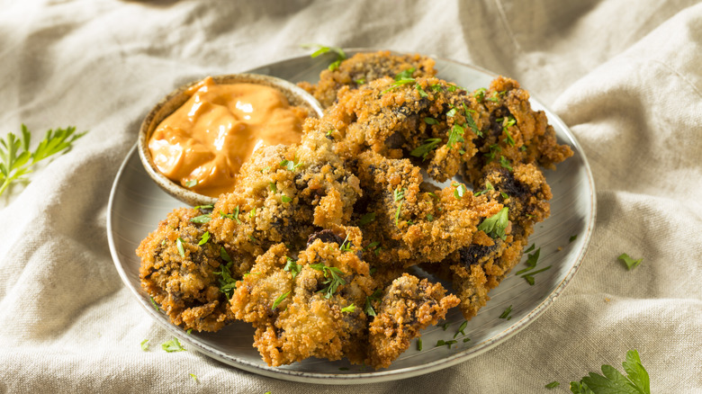 Fried chicken livers on a plate with sauce