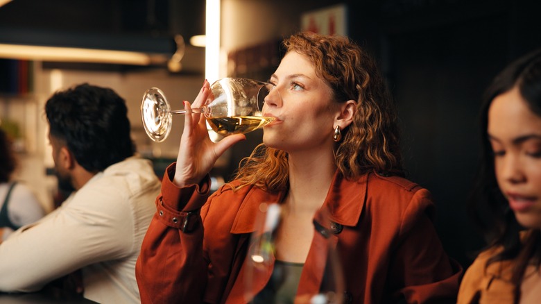 Woman drinking from a wine glass at a restaurant