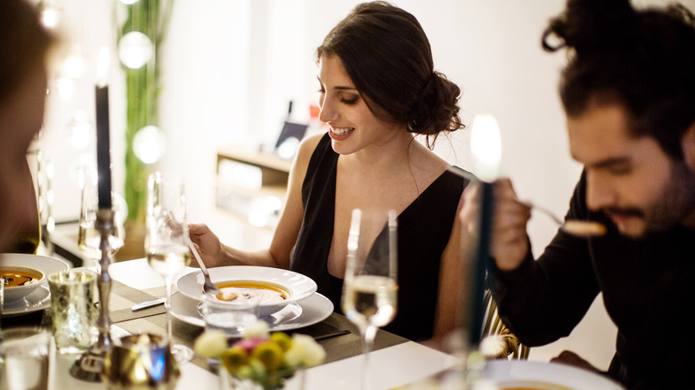 Couple enjoying the soup course at a fancy restaurant