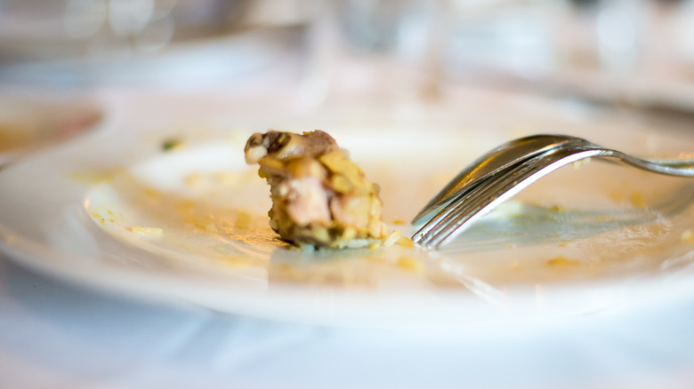 Bite of food left on a white plate