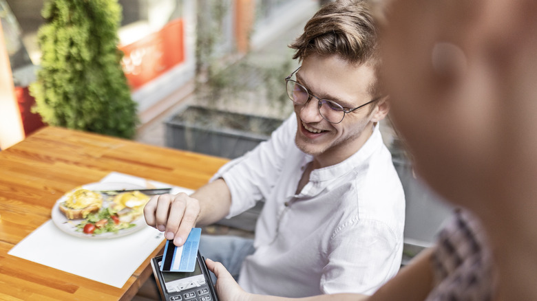 Man paying the bill at a restaurant