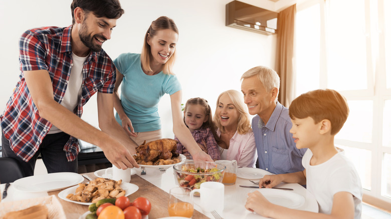 People getting seated for a family dinner