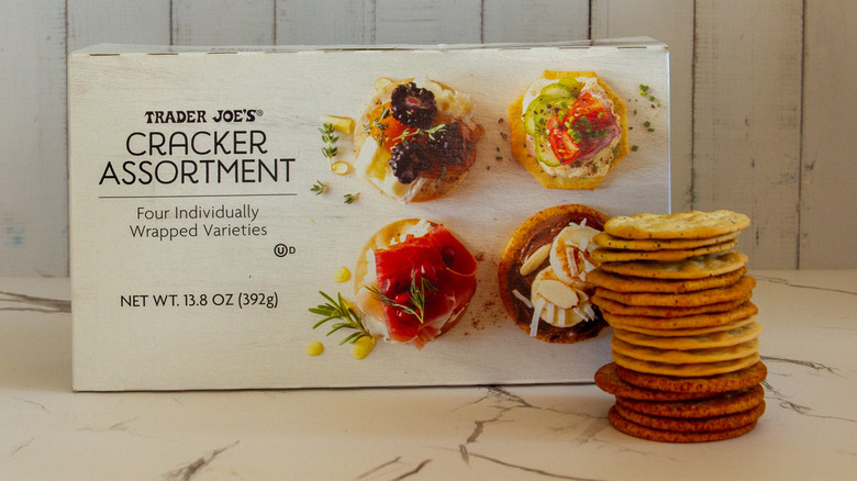 A stack of Trader Joe's assorted crackers next to the box