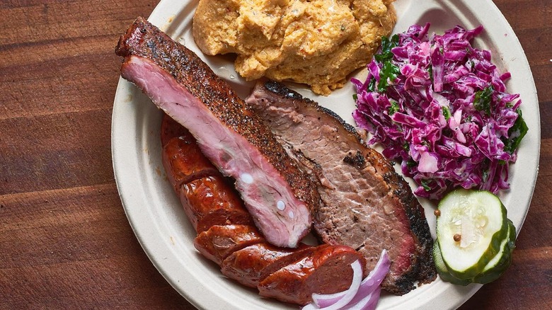 A plate of brisket, ribs, sausage, and sides at Micklethwait Craft Meats