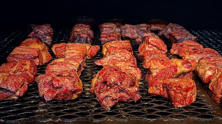Cuts of beef on a grill at Tejas Chocolate + Barbecue