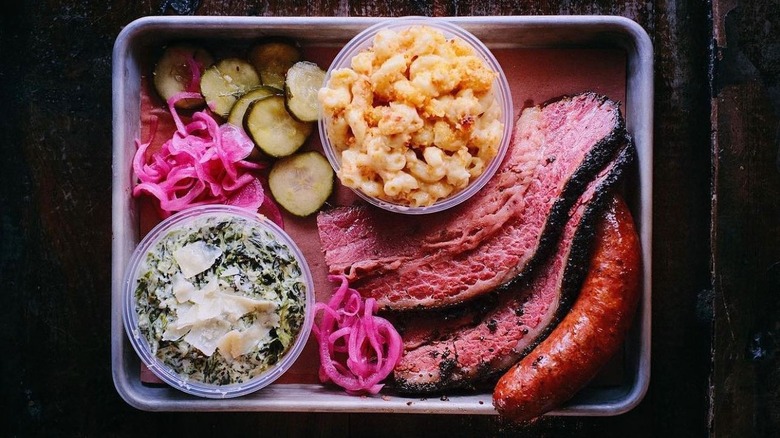 A plate of brisket, sausage, and sides at Truth BBQ