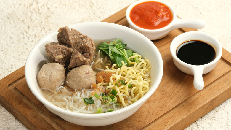 A bowl of bakso with sambal and kecap manis