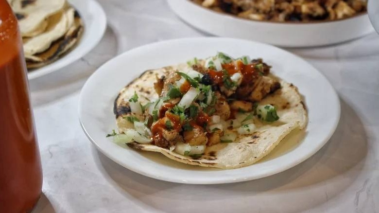 A Chicken Adobado Street Taco on a plate