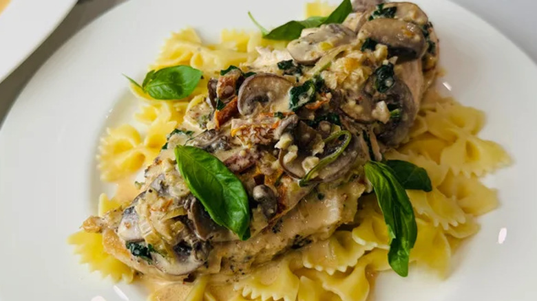 Classic creamy Tuscan chicken served on pasta