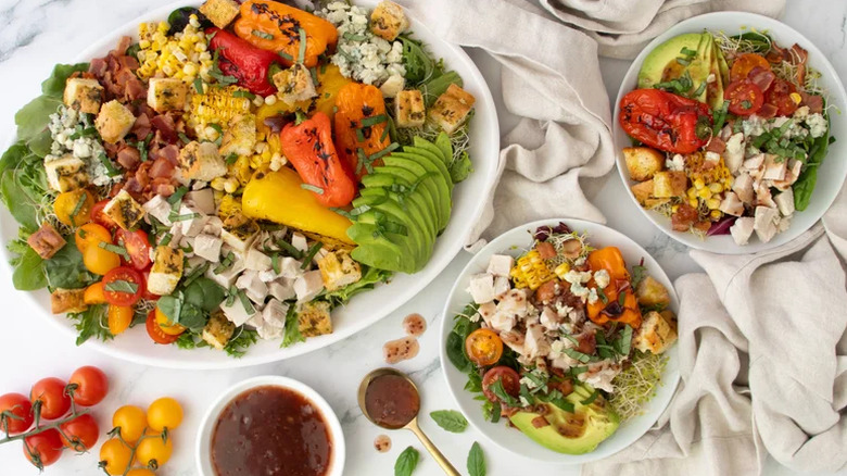 Rotisserie chicken salad with hot bacon and raspberry dressing