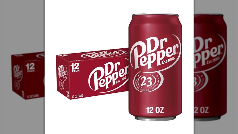 12-pack of Dr. Pepper cans with a 12-ounce can in the foreground of the photo on a white background.
