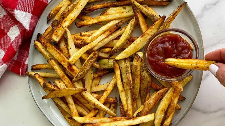Plate of french fries and ketchup