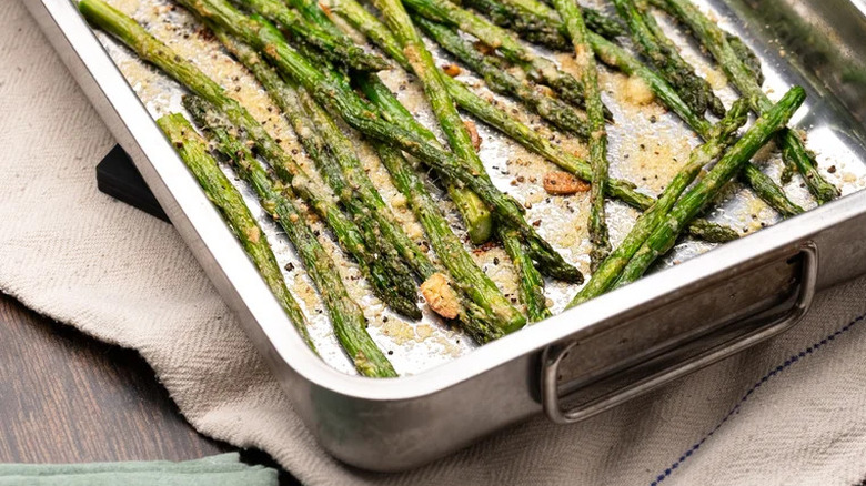 Baking pan of asparagus with Parmesan