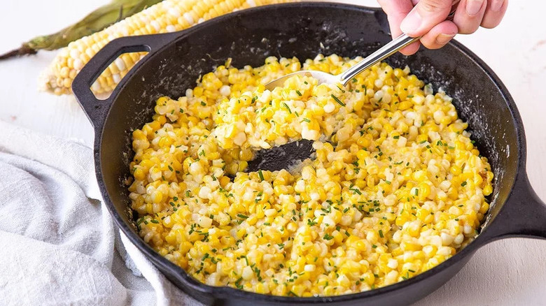Skillet of fried corn with herbs