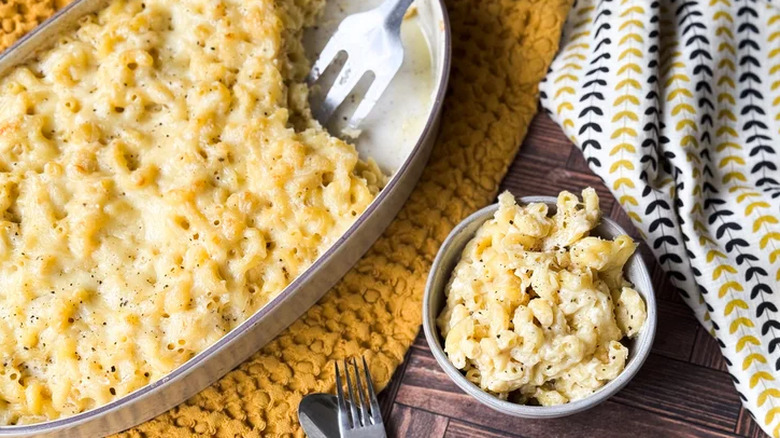 Baked macaroni in a dish with serving utensils