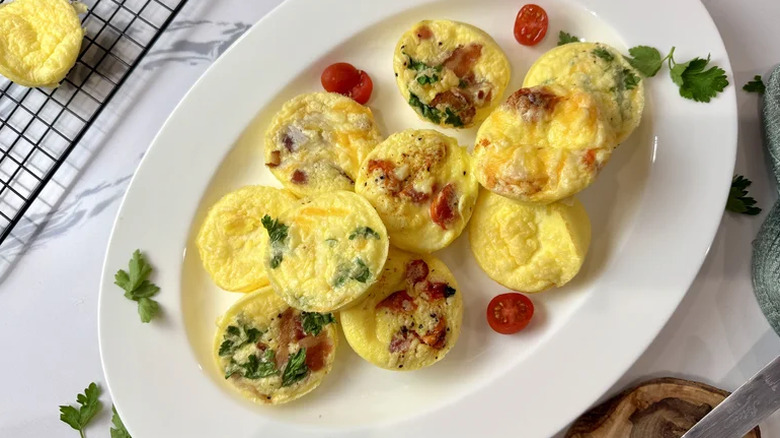 Egg bites on a plate with tomatoes
