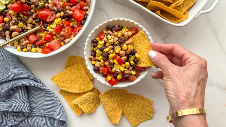 Cowboy caviar in a bowl with a hand