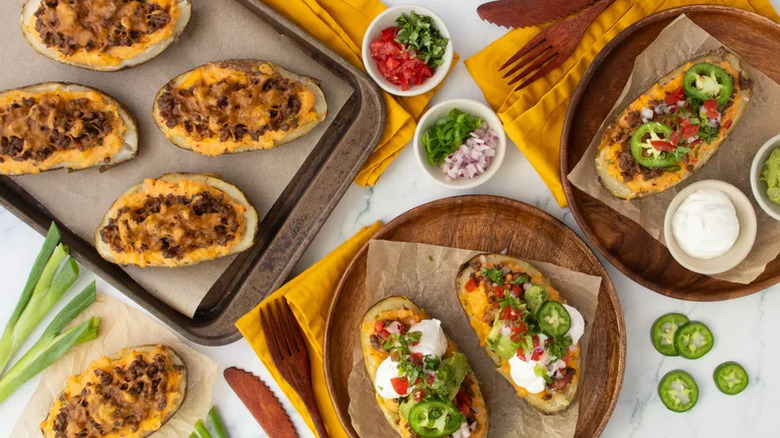Taco baked potatoes on plate with toppings