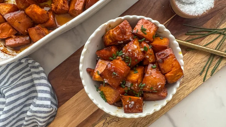 Bowl of candied yams with herbs