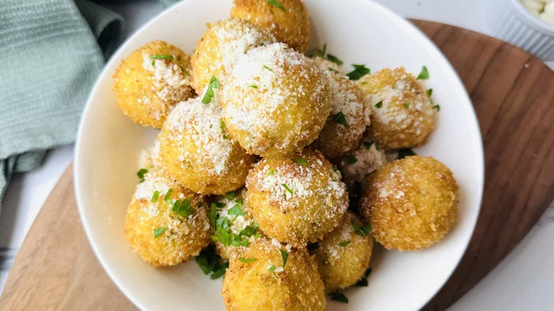 Cheesy mashed potato balls in a dish