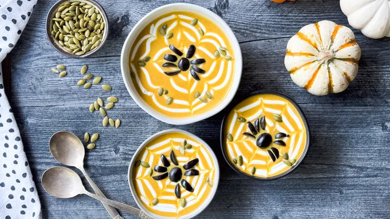 Pumpkin curry soup in bowls with pumpkin