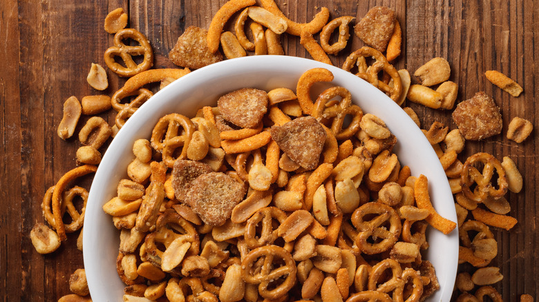 Snack mix coming out of bowl on table