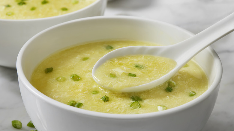Egg drop soup in white bowl