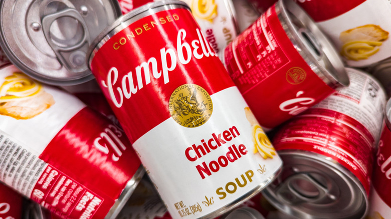A pile of cans of Campbell's Chicken Noodle Soup.