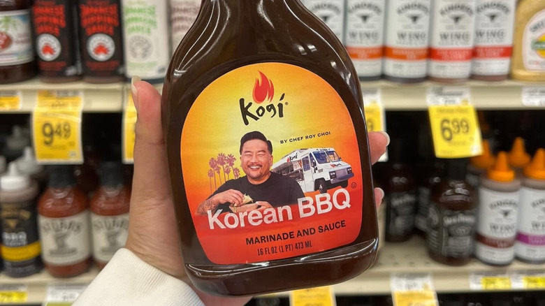 A hand holds Kogi BBQ sauce.