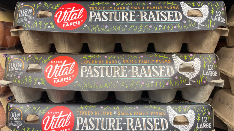 Carton of Vital Farms eggs with two outside.