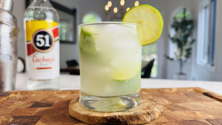 Caipirinha cocktail garnished with lime wheel
