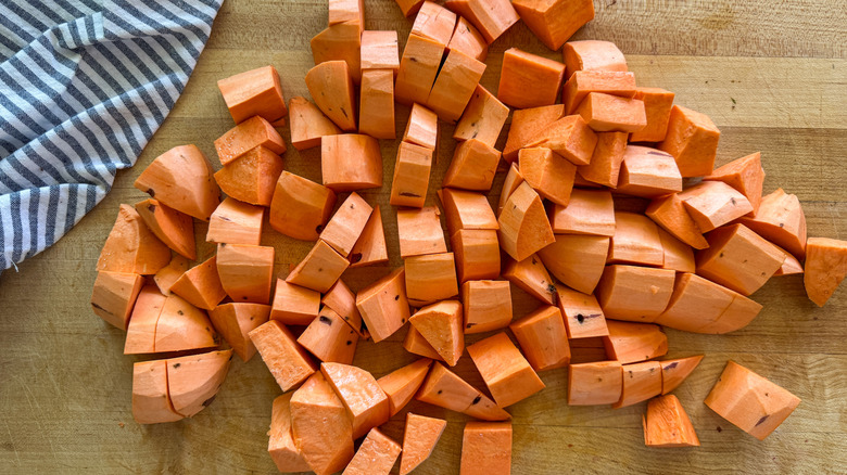 chopped sweet potatoes on board
