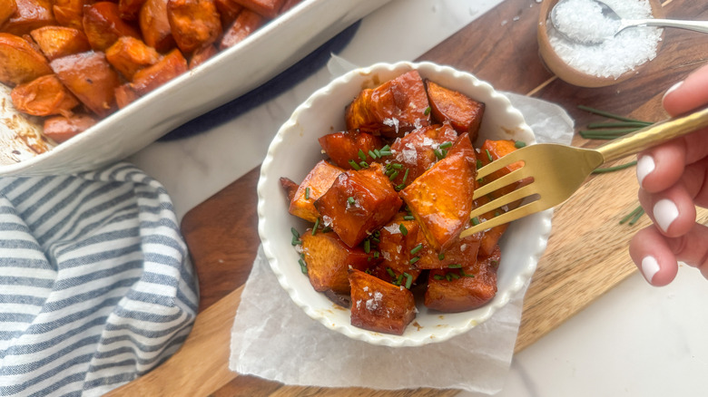 hand with fork in sweet potato