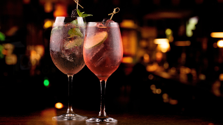 two lillet spritzes with busy bar in the background