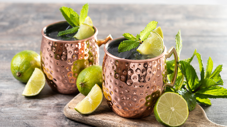 two Moscow mules with array fresh mint and sliced limes