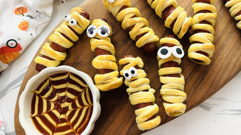 Mummy hot dogs with ketchup and mustard sauce