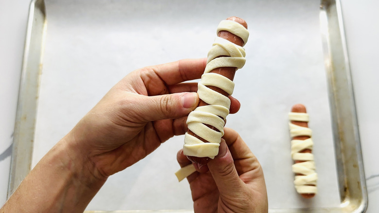 Wrapping hot dogs with puff pastry