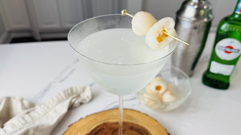 lychee martini close up with lychee garnish on a pick