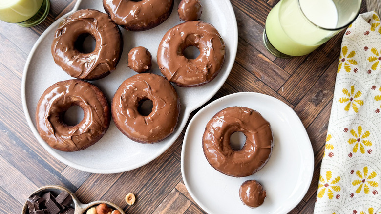 3-ingredient Nutella donuts on serving platter and plate with milk and napkin