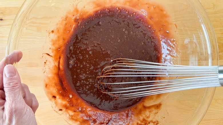 Whisking together eggs and Nutella in glass bowl