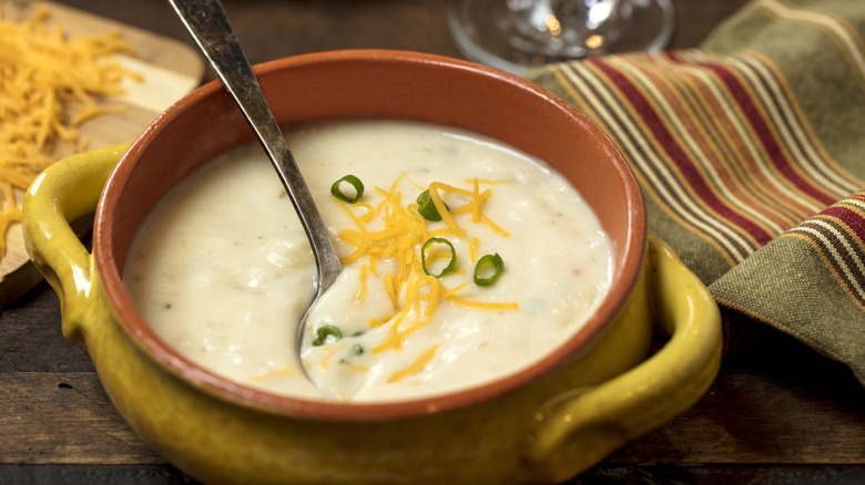 A bowl of creamy potato soup in a crock.