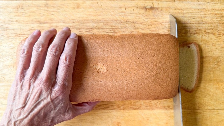 Trimming poundcake on cutting board