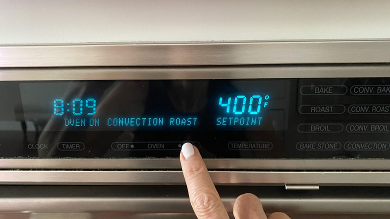 Finger setting the oven temperature