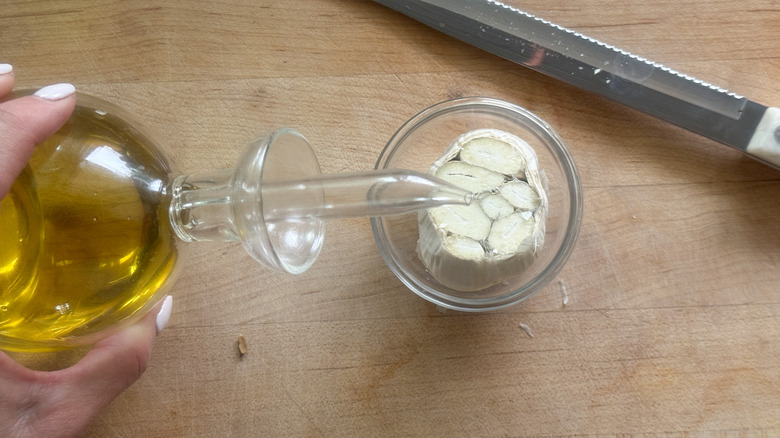 hand pouring oil on cloves