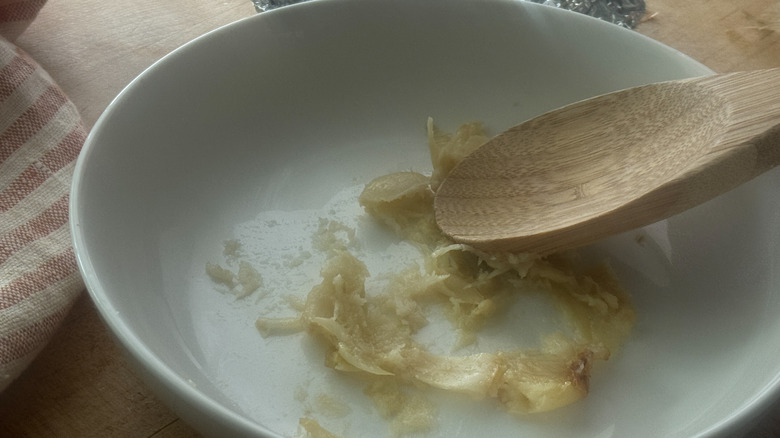 wooden spoon mashing cloves